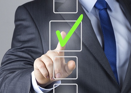 man points with his hand at an illustrated square in front of him with a green check mark in it