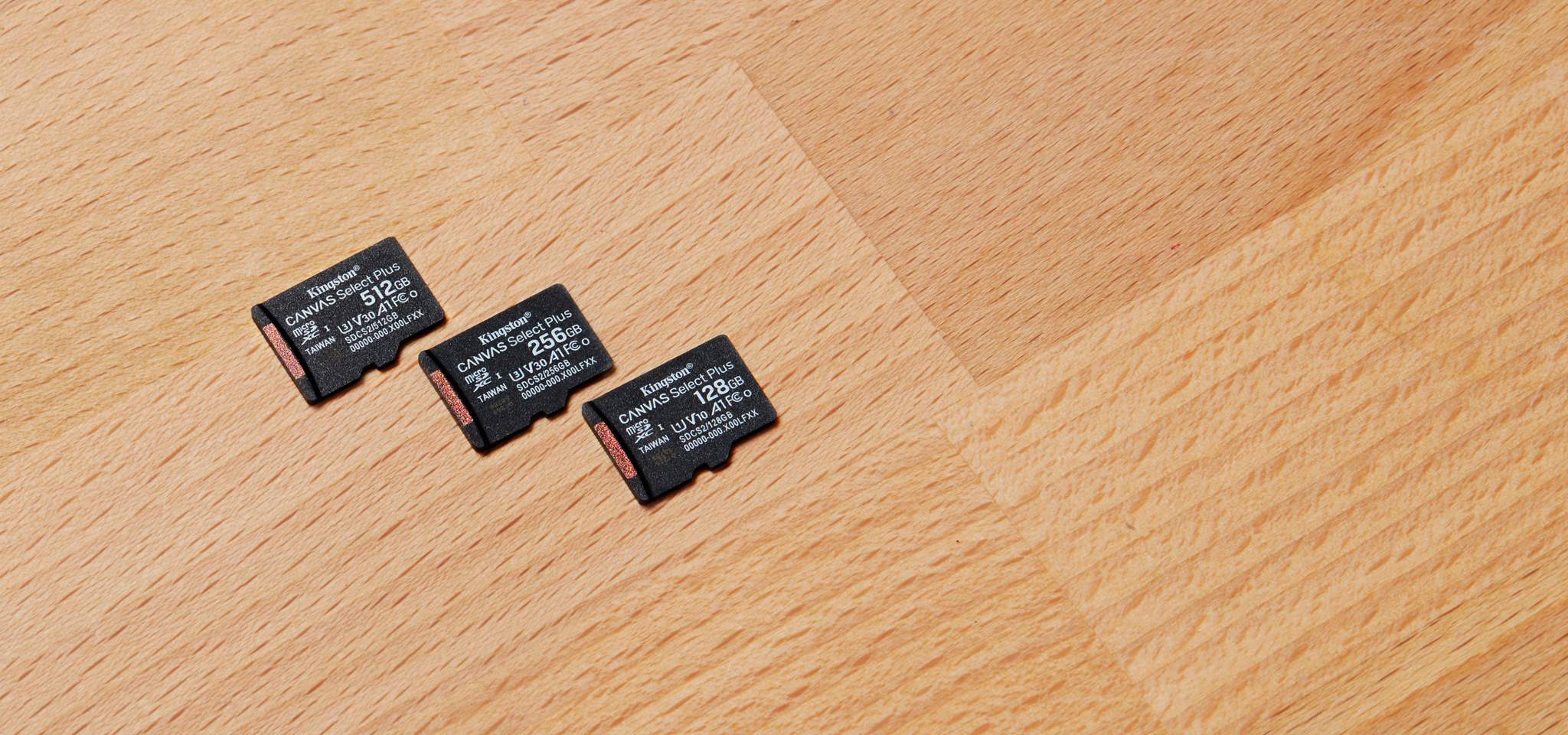 Tre schede Canvas Select Plus microSD, ognuna di diversa capacità, su una scrivania in legno