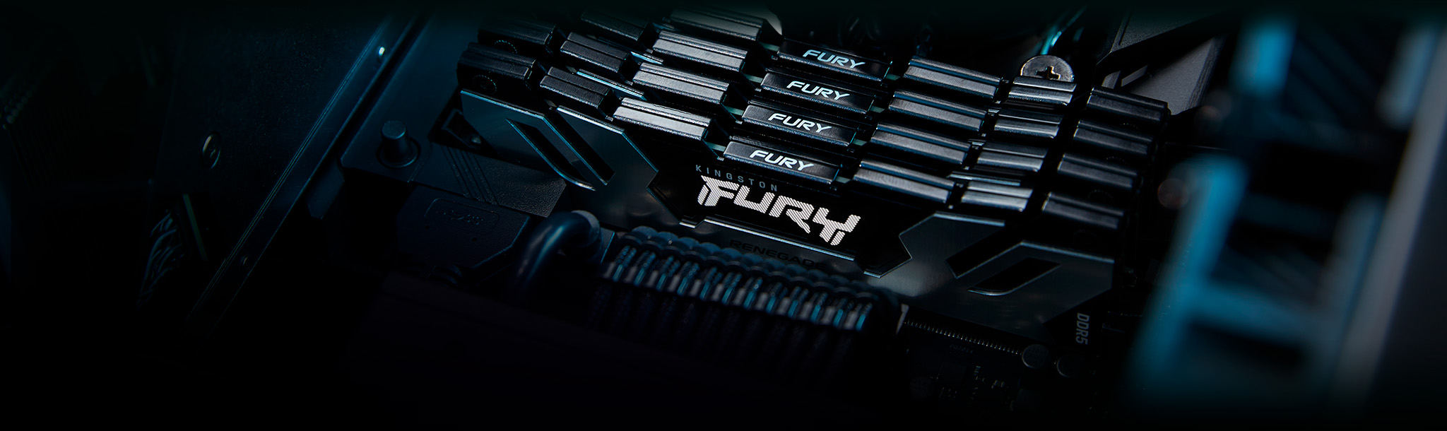 An angled view of four Kingston FURY Renegade DDR5 memory modules, in black, mounted inside a motherboard